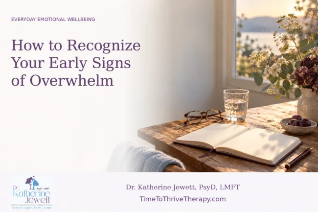 Open notebook, eyeglasses and a glass of water on a sunlit table beside a window.